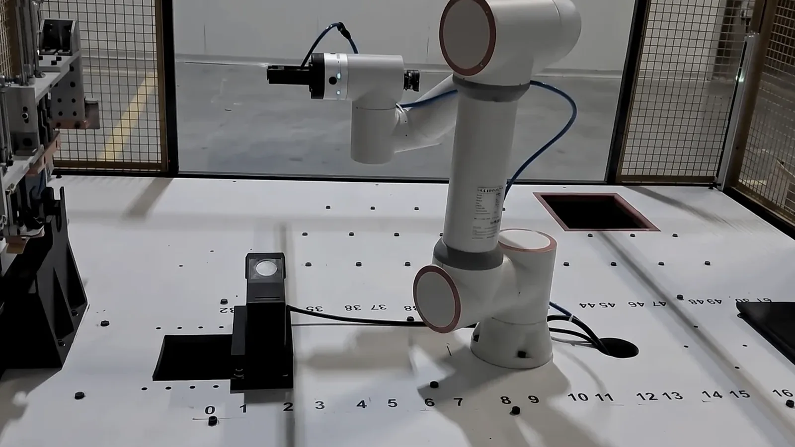 The robot arm carrying the scanner head inside the Jaguar inspection cell